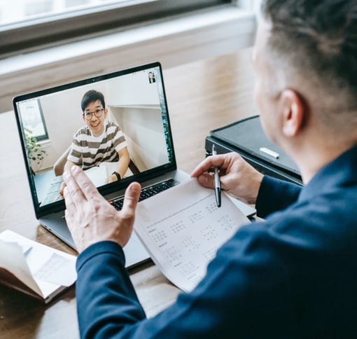 men in online meeting at his desk